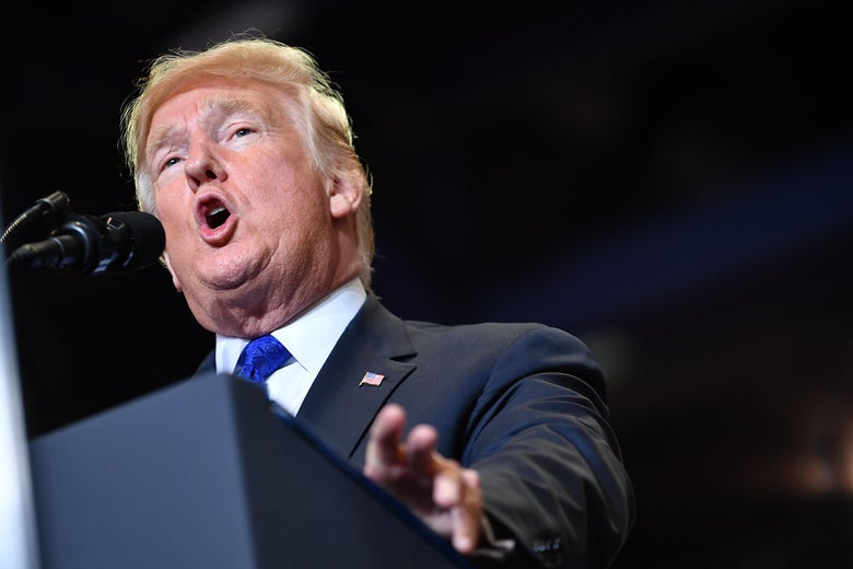 Trump speaks at a podium.